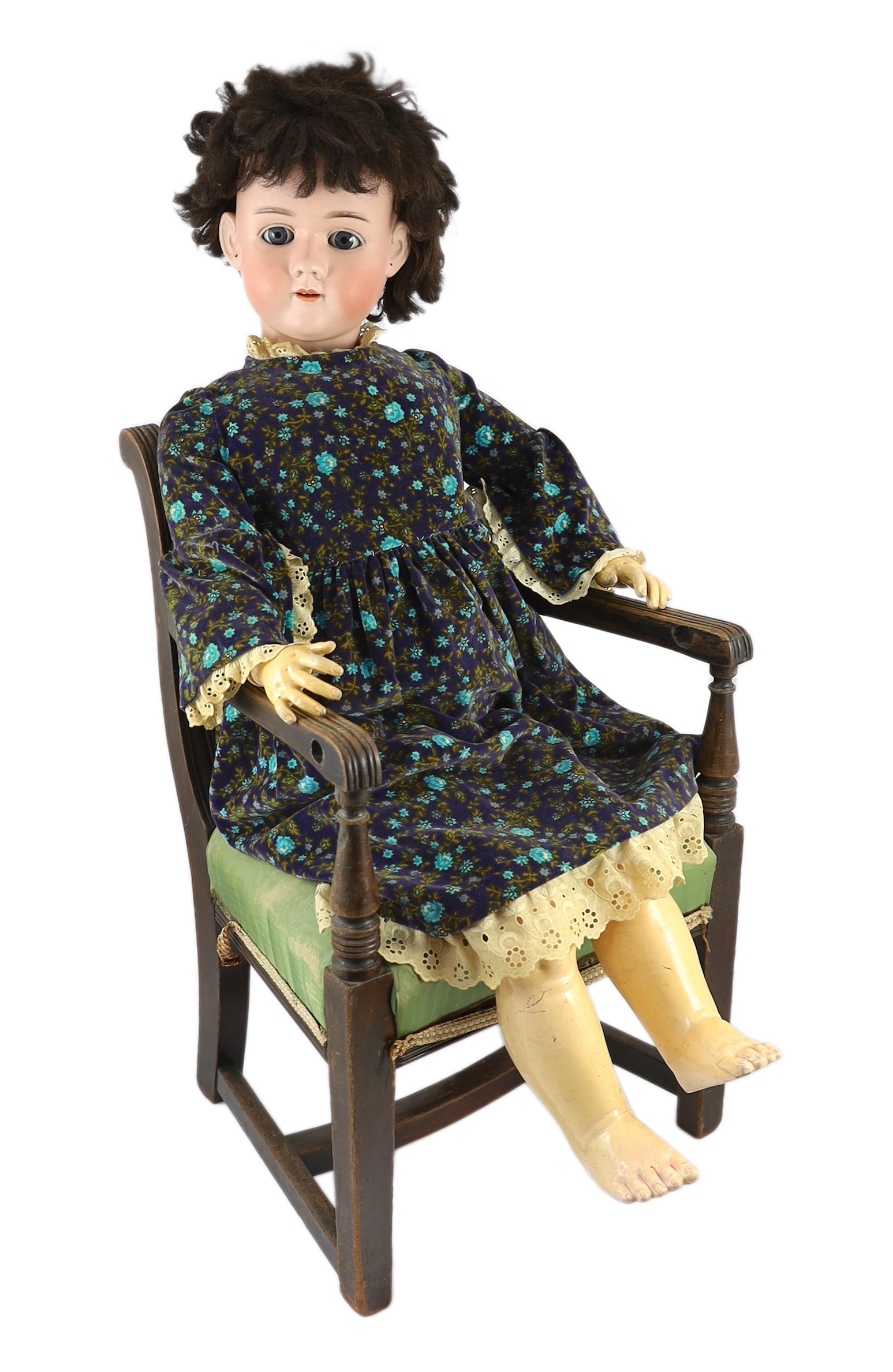 A Heinrich Handwerck bisque doll, German, circa 1900, 33in. Please note the chair is for display purposes only.